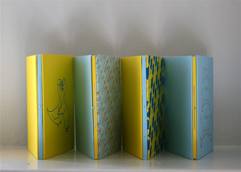 Set of four artist books (L-R): "Transitions", "Mostly Relationships" "Medicine" and "Crimes" by Zoe Phillips (2013) 